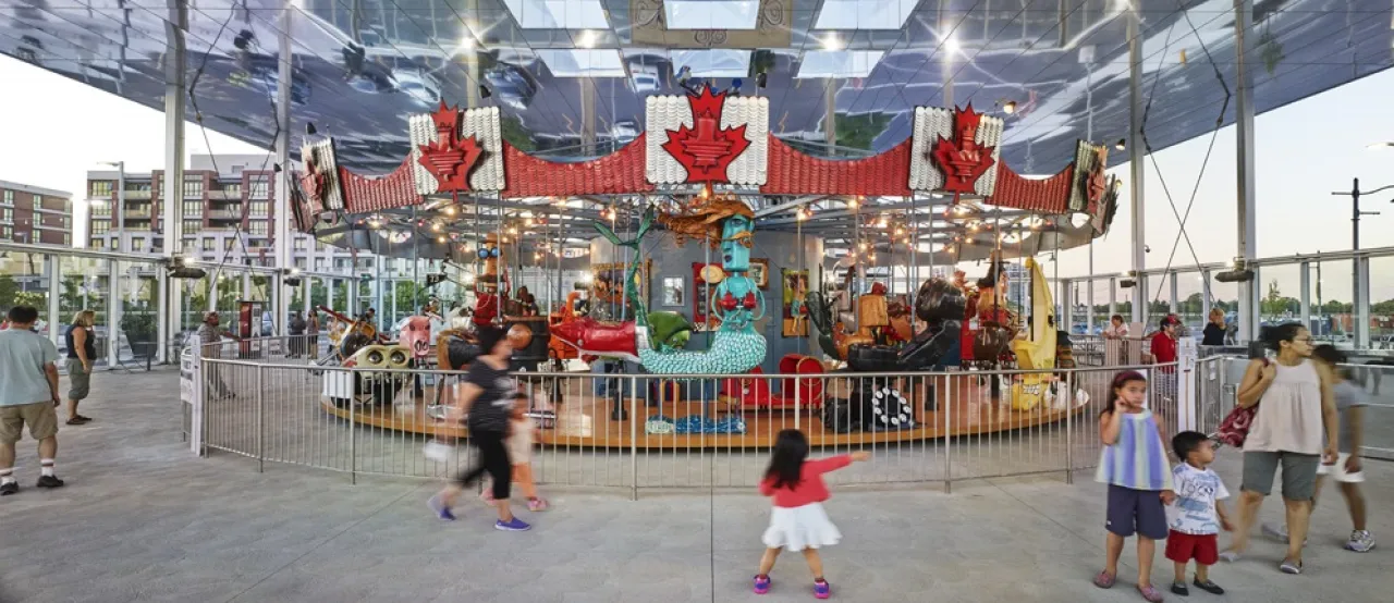 People playing on the Pride of Canada Carousel.