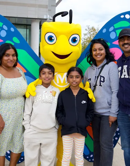 Millie mascot with a family.