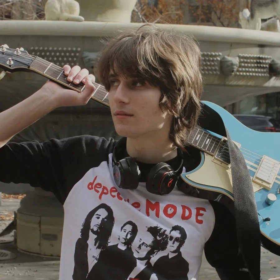 Musician Logan Levi holding a guitar.