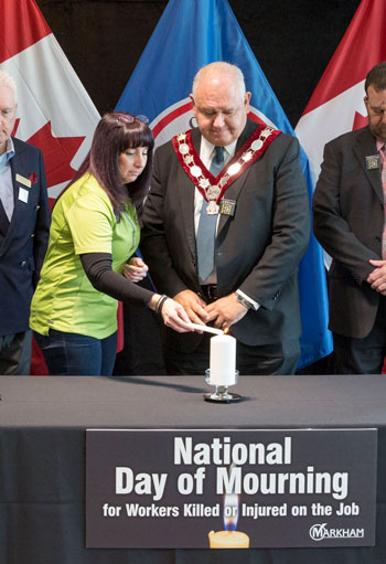 Johanna LeRoux, Threads of Life guest speaker lights a candle with Mayor Frank Scarpitti to honour those who have been killed or injured in a workplace incident.